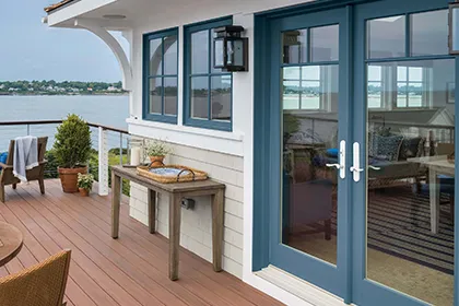 Coastal home with large composite deck features Marvin Signature Ultimate Outswing French Doors