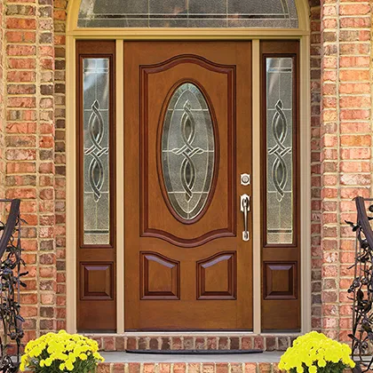 This brick facade home is a stately background for the decorative glass door, side lites and arched transom from Therma-Tru fiberglass doors
