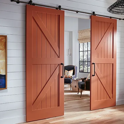 The crisp detail of these TruStile MDF interior barn doors compliments the ship lap siding in this hallway