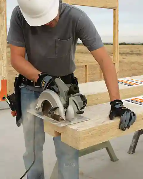 Contractor using a circular saw to field trim a Simpson Wood Strong-Wall shearwall at the job site