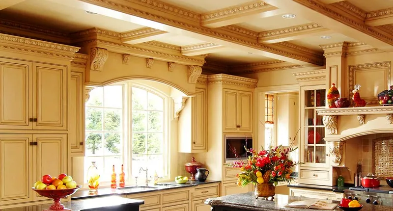This ornate residential kitchen uses Metrie El & El fine wood mouldings, high-relief mouldings and hand-carved friezes