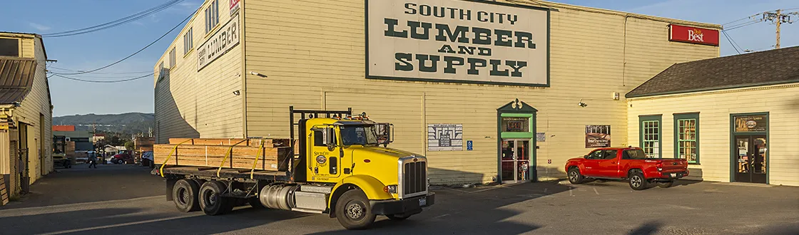 Streetside view of South City Lumber & Supply Company with delivery truck