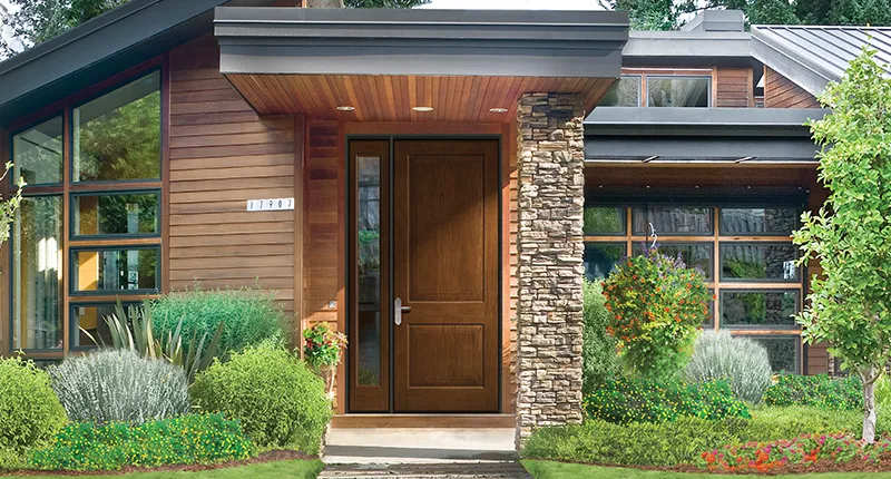 One side lite compliments the oversized fiberglass door from Therma-Tru in this curb side view of a contemporary home
