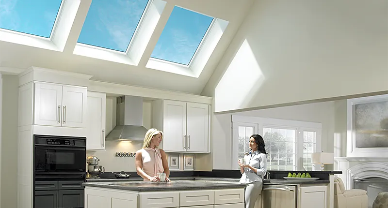 Modern kitchen with high ceiling and three VELUX fixed skylights provide natural light and offer views of the sky