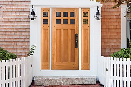 A remodeled home with wood front entry door and side lites by Simpson Door Company compliments the Colonial style