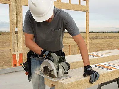 Contractor using a circular saw to field trim a Simpson Strong-Wall shearwall at the jobsite