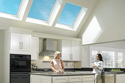 Modern kitchen with high ceiling and three VELUX fixed skylights provide natural light and offer views of the sky