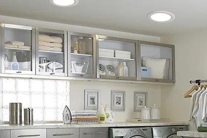 This light and airy laundry room is flooded with light from a pair of highly efficient VELUX Sun Tunnel Skylights